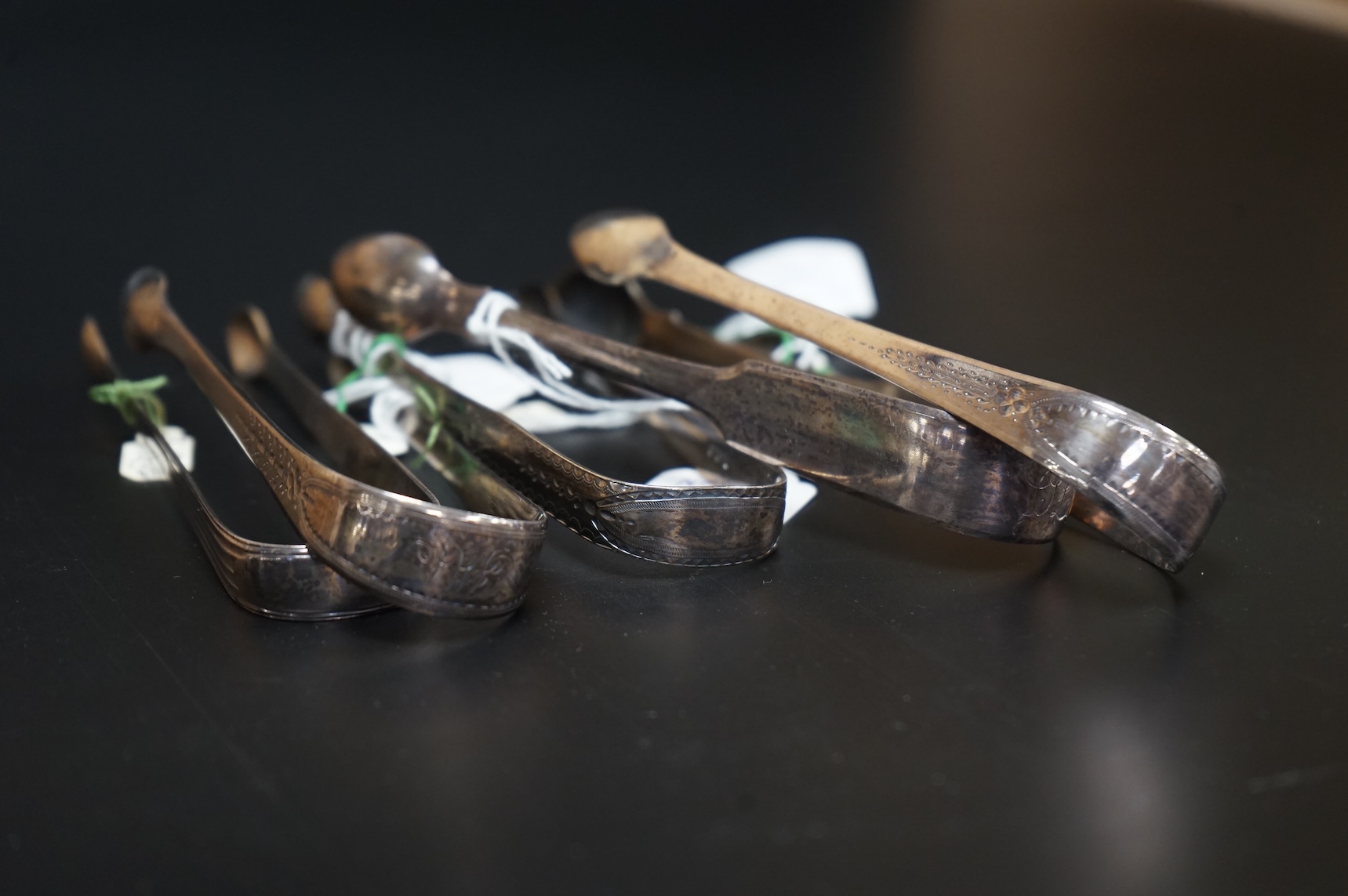 Five assorted pairs of Georgian silver sugar tongs, including four George III, one by Peter & Ann Bateman, London, 1797 largest 13.3cm.